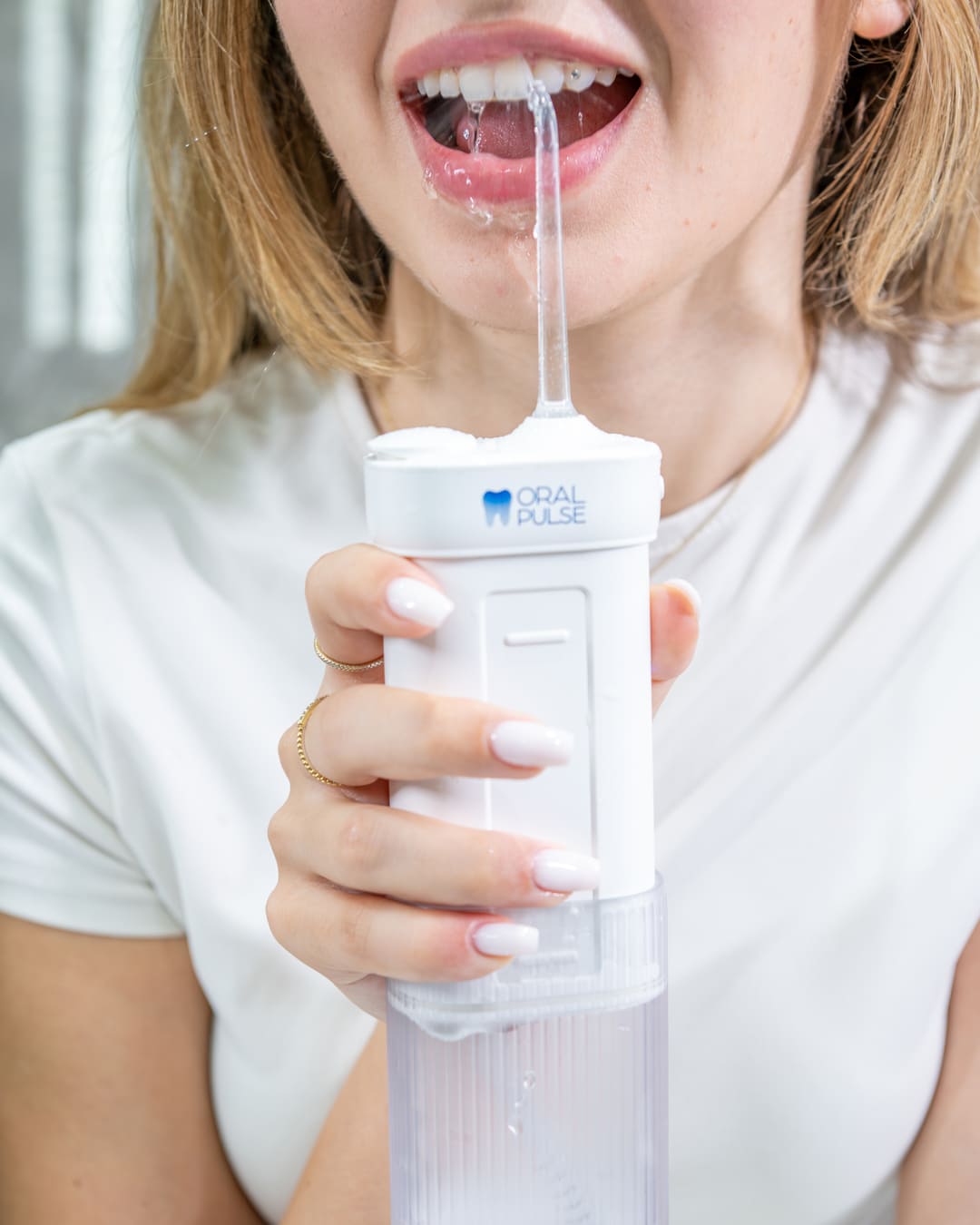 Model using the portable water flosser in Lebanon by oral pulse