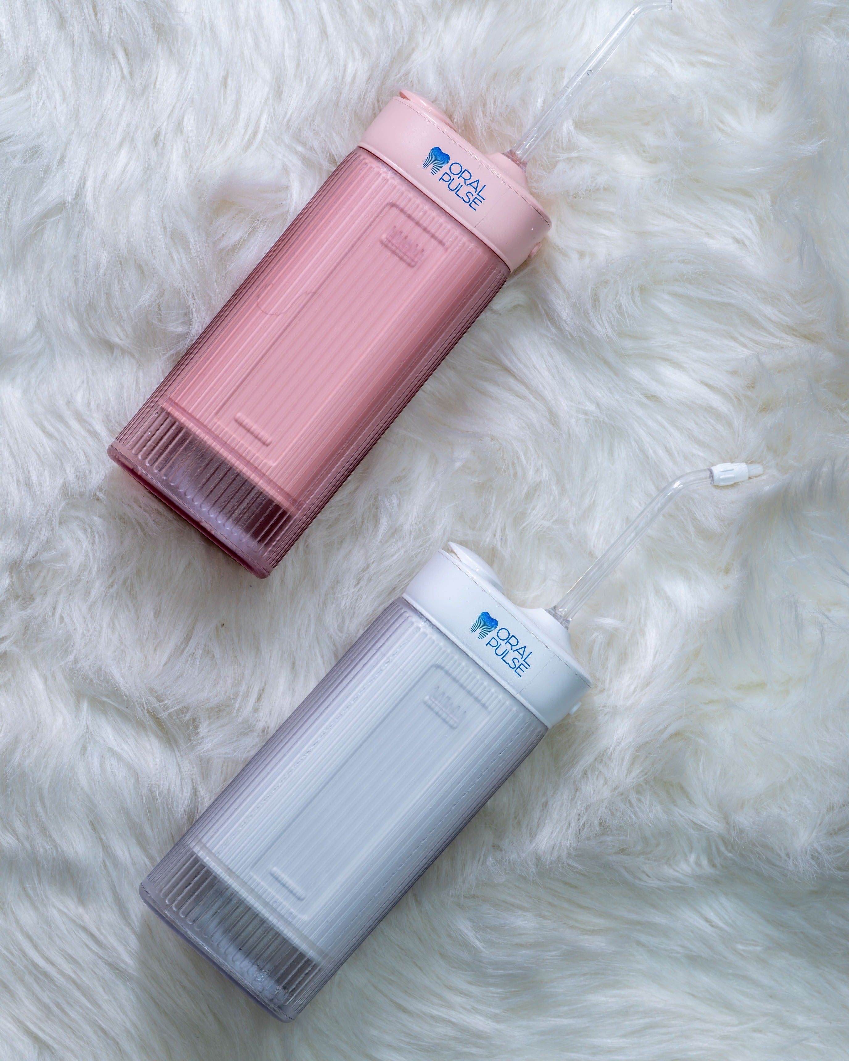 white and pink portable water flossers